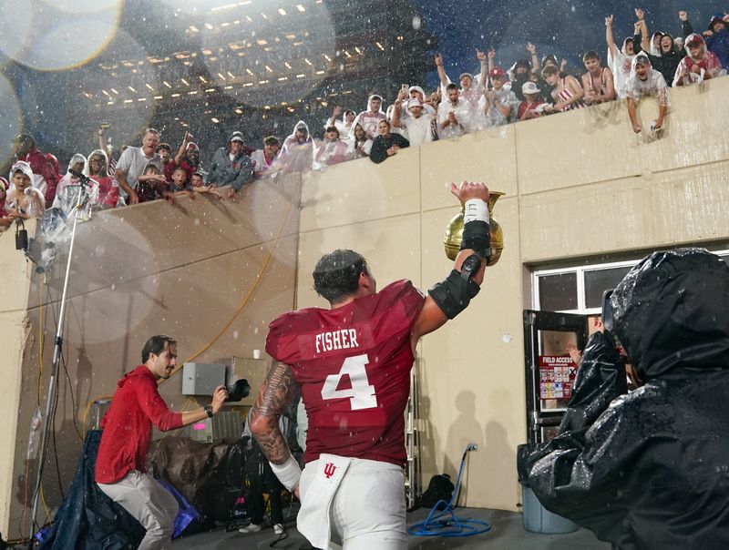 Indiana Hoosiers linebacker Aiden Fisher (4) celebrates with the Old Brass Spittoon after the game against the Michigan State Spartans at Memorial Stadium on Saturday, Oct. 18, 2025.