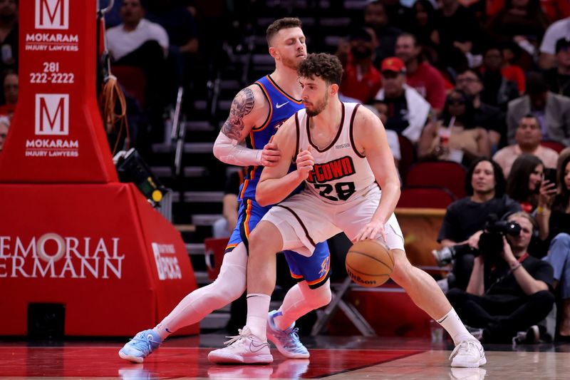 Houston Rockets center Alperen Sengun handles the ball inside against Oklahoma City Thunder center Isaiah Hartenstein during the third quarter at Toyota Center.