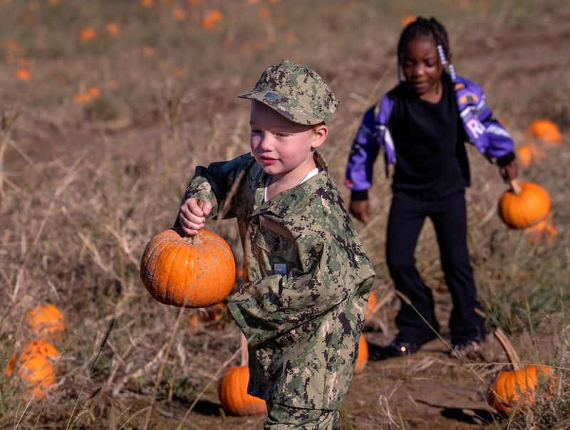 Erskine Elementary School kindergartner Jackson Long and his classmates pick pumpkins at Russell Farms, Monday, Oct. 20, 2025 in Noblesville.