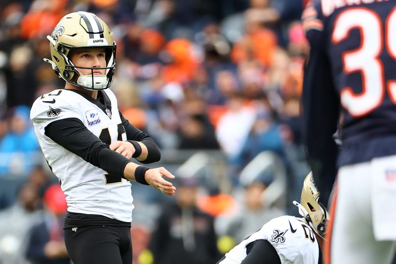 Oct 19, 2025; Chicago, Illinois, USA; New Orleans Saints kicker Blake Grupe (19) gets set kick a PAT against the Chicago Bears during the second half at Soldier Field. Mandatory Credit: Mike Dinovo-Imagn Images