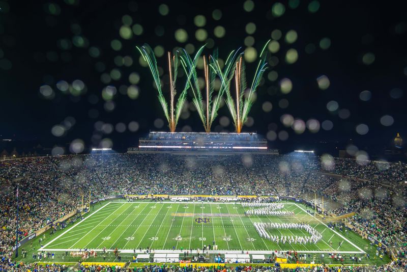 Oct 18, 2025; South Bend, Indiana, USA; Fireworks go off as Notre Dame Fighting Irish players run onto the field before the game against the Southern California Trojans at Notre Dame Stadium. Mandatory Credit: Michael Caterina-Imagn Images