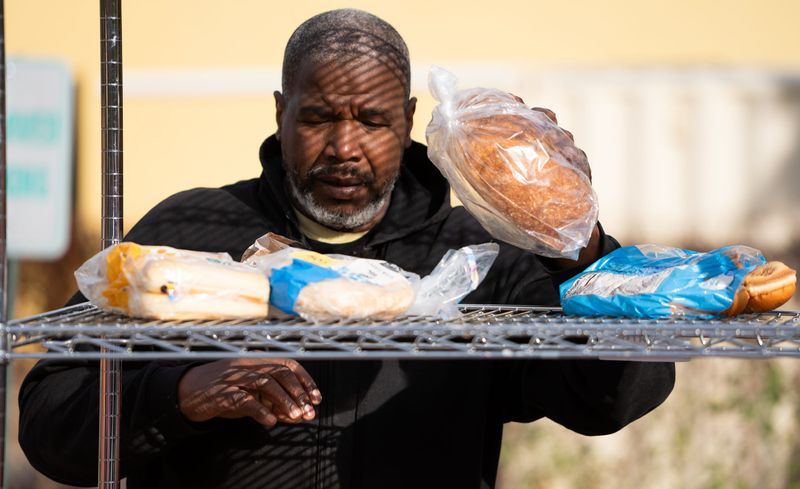 John Bridgeforth, a volunteer at Mid-North Food Pantry, loads bread Monday, Oct. 27, 2025, at Mid-North Food Pantry just off Meridian Street in Indianapolis.