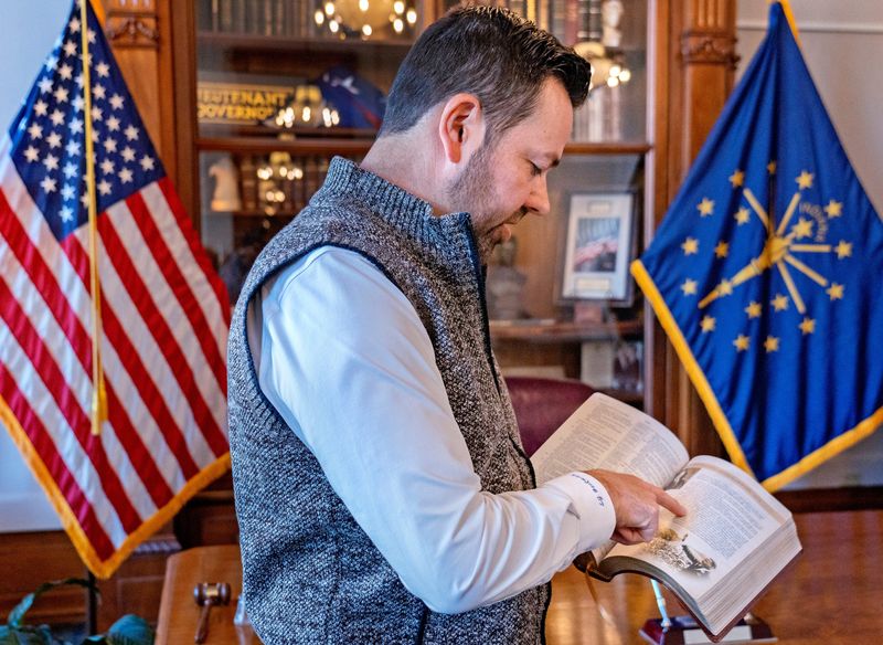 Lt. Gov. Micah Beckwith shows one of the several Bibles he has in his office Monday, Oct. 20, 2025 at the Indiana Statehouse.