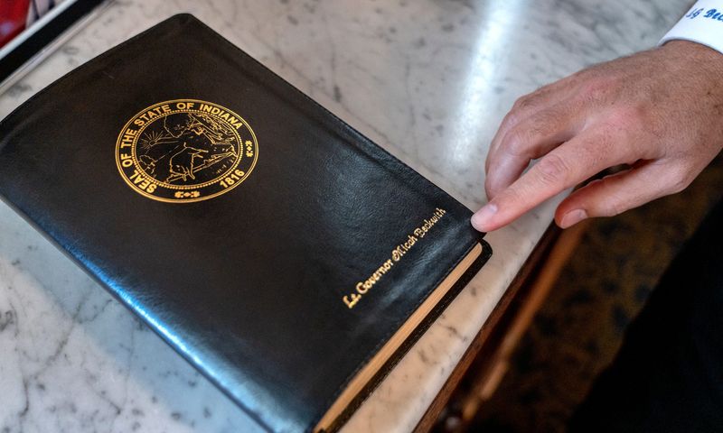 Lt. Gov. Micah Beckwith shows one of the Bibles in his office Monday, Oct. 20, 2025 at the Indiana Statehouse.