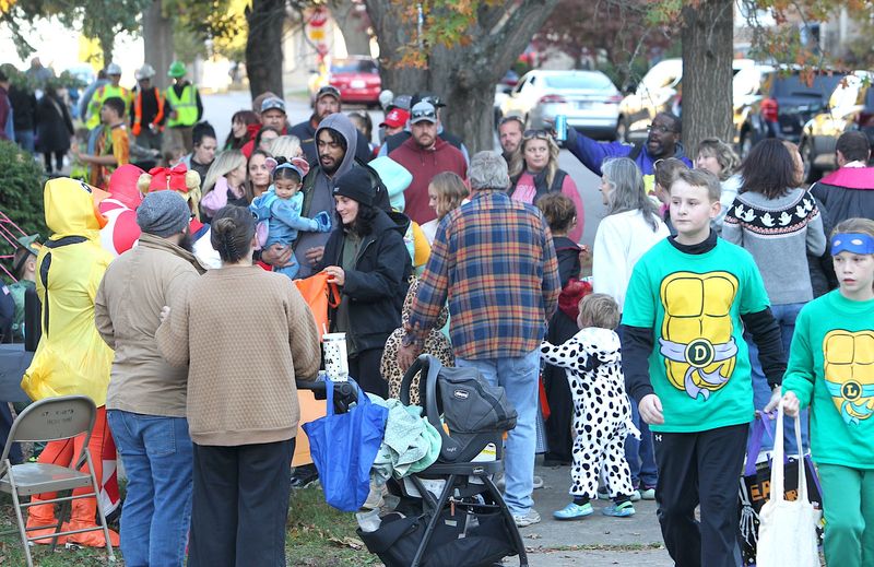 A mob of trick-or-treaters converge at the intersection of 14th and M streets on Friday, Oct. 31, 2025, in Bedford.