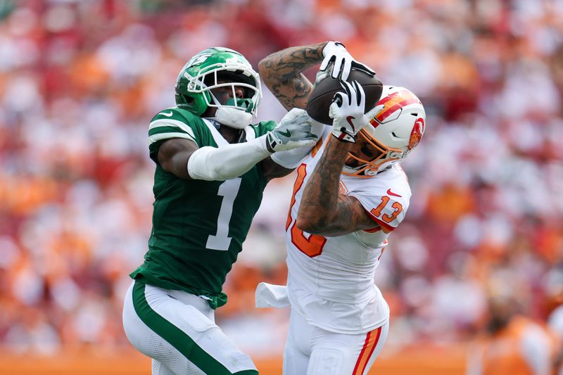 Sep 21, 2025; Tampa, Florida, USA; Tampa Bay Buccaneers wide receiver Mike Evans (13) catches pass defended boy New York Jets cornerback Sauce Gardner (1) in the third quarter at Raymond James Stadium. Mandatory Credit: Nathan Ray Seebeck-Imagn Images