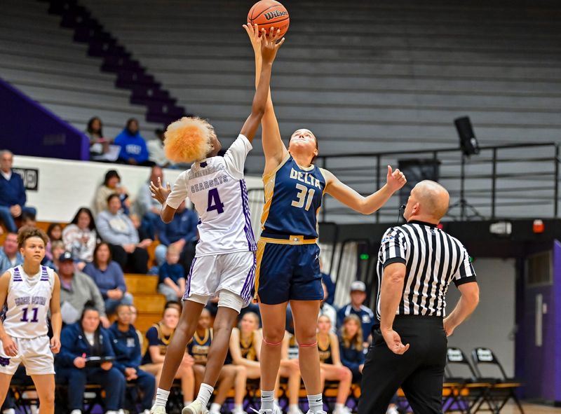 Delta's Jillian Barr (31) and Muncie Central's Kei'Maija Hickey (4) tip off the 2025-26 girls basketball season at the Muncie Fieldhouse on Thursday, Nov. 6, 2025.