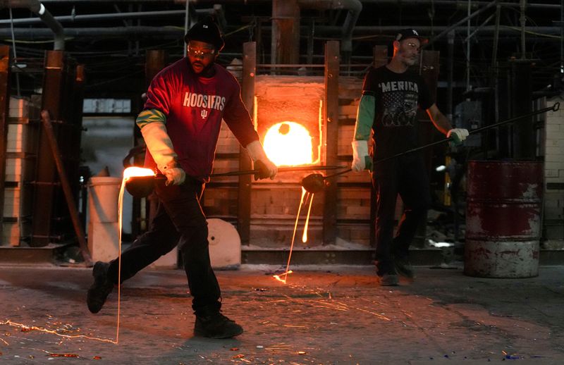 Ray McGee uses a ladle to move molten glass, which will be turned into glass sheets, on Wednesday, Oct. 29, 2025, Kokomo Opalescent Glass in Kokomo, Ind.