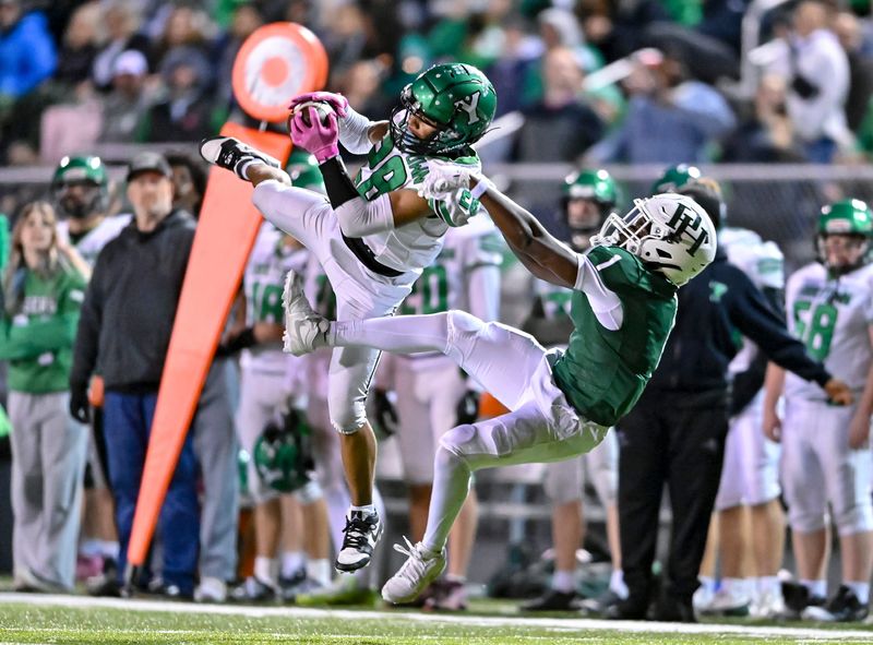 Yorktown junior Kaden Crumes (28) comes down with a spectacular interception during an IHSAA Class 4A football sectional championship game against Pendleton Heights Friday, Nov. 7, 2025, at Pendleton Heights High School.