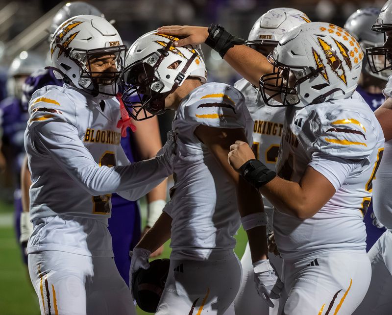 North's Nate Walker (2) and James Mason (54) congratulate Luke Freel on his touchdown during the Bloomington South versus Bloomington North IHSAA sectional football final at Bloomington High School South on Friday, Nov. 7, 2025.