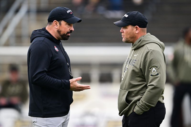 Nov 8, 2025; West Lafayette, Indiana, USA; Ohio State Buckeyes head coach Ryan Day speaks with Purdue Boilermakers head coach Barry Odom before the game at Ross-Ade Stadium. Mandatory Credit: Marc Lebryk-Imagn Images