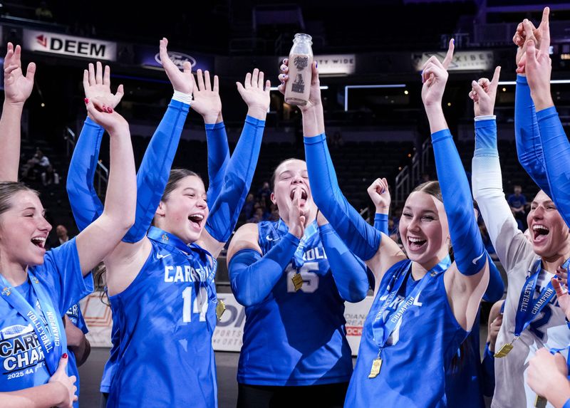 The Carroll Chargers celebrate Saturday, Nov. 8, 2025, after winning the Class 4A girls volleyball state championship game between Plainfield and Fort Wayne Carroll at Gainbridge Fieldhouse in Indianapolis. The Carroll Chargers won in three sets.