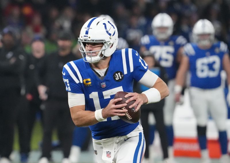 Nov 9, 2025; Berlin, Germany; Indianapolis Colts quarterback Daniel Jones (17) runs the ball against the Atlanta Falcons during the NFL Berlin Game at Olympic Stadium. Mandatory Credit: Kirby Lee-Imagn Images
