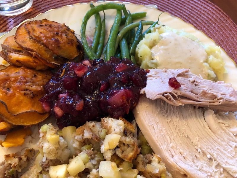 A Thanksgiving meal with turkey, Social Butterfly's cranberry sauce, roasted sweet potatoes, stuffing, green beans, mashed potatoes and gravy,