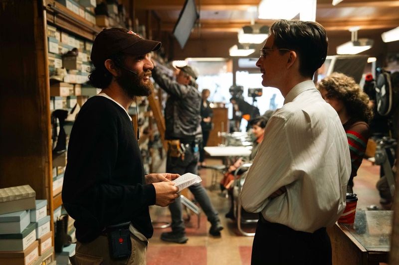 Timothy Chalamet (right, with director Josh Safdie) plays a shoe salesman with big dreams of being a ping-pong world champion in "Marty Supreme."