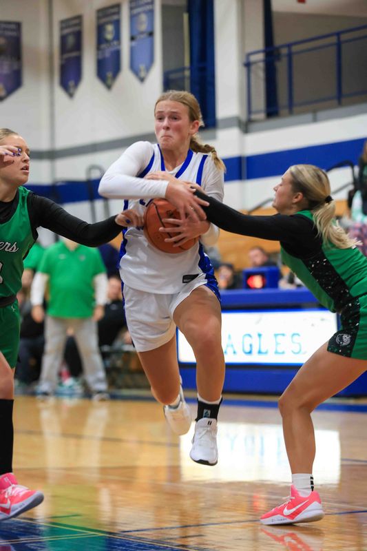 Heritage Christian's Elyse Snively (21) attempts to drive to the basket as Heritage Christian took on Triton Central High School in IHSAA Girls Basketball on Nov 11, 2025; Indianapolis, IN; at Heritage Christian HS.