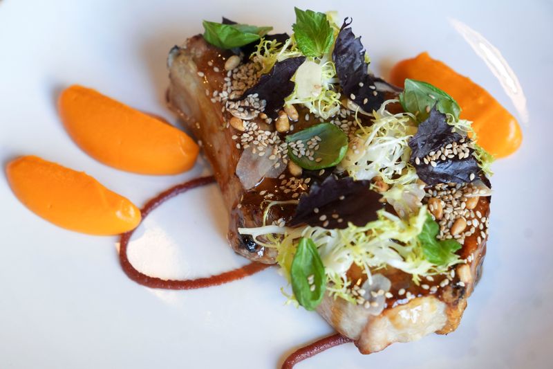 A Gunthorp pork chop is pictured Wednesday, Nov. 12, 2025, at Bluebeard in Indianapolis. The dish features pine nuts, dates and a lemon shoyu butter, along with other ingredients.