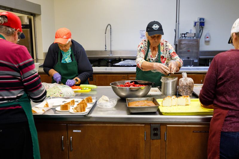Patty Suddarth, left, and Kathy Rose, right, make preparations ahead of Wednesday's lunch service at Downtown Soup Kitchen at First United Methodist Church on Wednesday, Nov. 12, 2025, in South Bend.