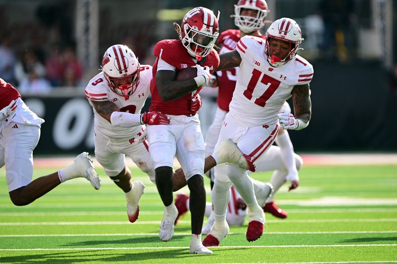 Nov 15, 2025; Bloomington, Indiana, USA; Indiana Hoosiers running back Roman Hemby (1) is tackled by Wisconsin Badgers safety Austin Brown (9) during the second half at Memorial Stadium. Mandatory Credit: Marc Lebryk-Imagn Images