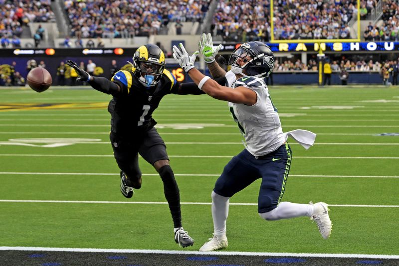Nov 16, 2025; Inglewood, California, USA; Los Angeles Rams cornerback Emmanuel Forbes Jr. (1) breaks up a pass intended for Seattle Seahawks wide receiver Jaxon Smith-Njigba (11) during the first half at SoFi Stadium. Mandatory Credit: Jayne Kamin-Oncea-Imagn Images