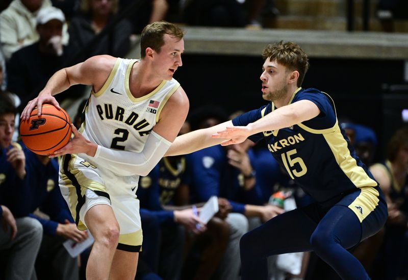 Nov 16, 2025; West Lafayette, Indiana, USA; Akron Zips guard Bowen Hardman (15) reaches for a ball controlled by Purdue Boilermakers guard Fletcher Loyer (2) during the first half at Mackey Arena. Mandatory Credit: Marc Lebryk-Imagn Images