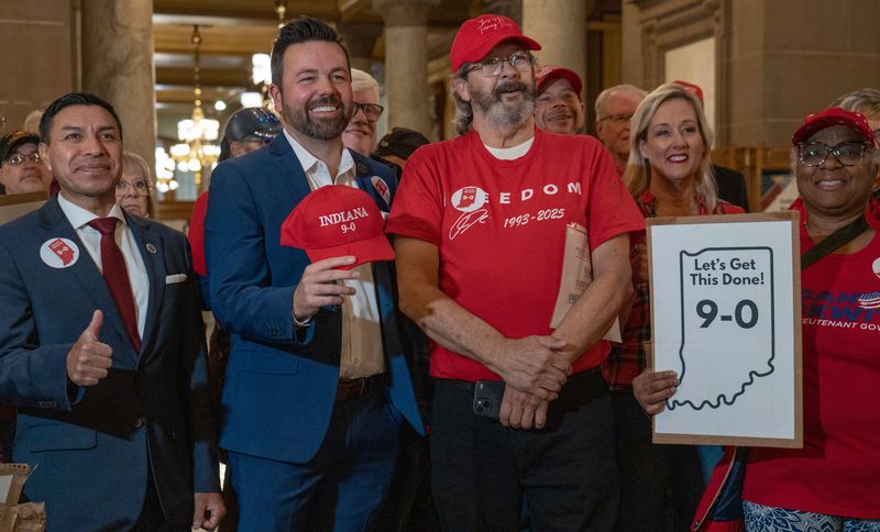 People gather for a photo during a pro-redistricting event Tuesday, Nov. 18, 2025 at the Indiana Statehouse. Included are Indiana Secretary of State Diego Morales, from left, and Lt. Gov. Micah Beckwith.