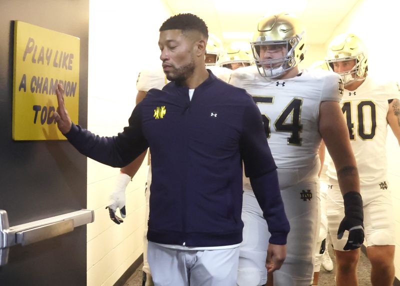 Nov 15, 2025; Pittsburgh, Pennsylvania, USA; Notre Dame Fighting Irish head coach Marcus Freeman leads the team from the locker room to play the Pittsburgh Panthers at Acrisure Stadium. Mandatory Credit: Charles LeClaire-Imagn Images