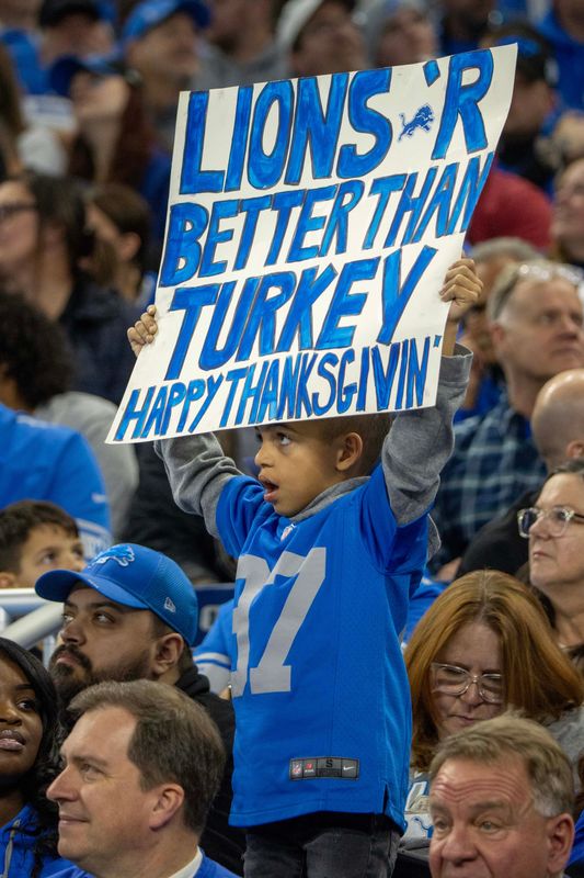 Nov 23, 2023; Detroit, Michigan, USA; A young Detroit Lions fans holds up his sign in the second quarter against the Green Bay Packers during the annual Thanksgiving Day game at Ford Field.