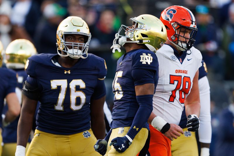 Notre Dame cornerback Leonard Moore, center, celebrates after returning an interception for touchdown in the first half of a NCAA football game against Syracuse at Notre Dame Stadium on Saturday, Nov. 22, 2025, in South Bend.