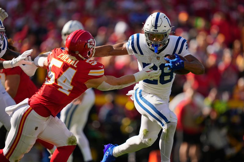 Nov 23, 2025; Kansas City, Missouri, USA; Indianapolis Colts running back Jonathan Taylor (28) runs against Kansas City Chiefs linebacker Leo Chenal (54) in the first quarter at GEHA Field at Arrowhead Stadium. Mandatory Credit: Jay Biggerstaff-Imagn Images