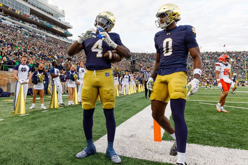 Notre Dame running back Jeremiyah Love (4) makes a heart sign after scoring a touchdown in the first half of a NCAA football game against Syracuse at Notre Dame Stadium on Saturday, Nov. 22, 2025, in South Bend.