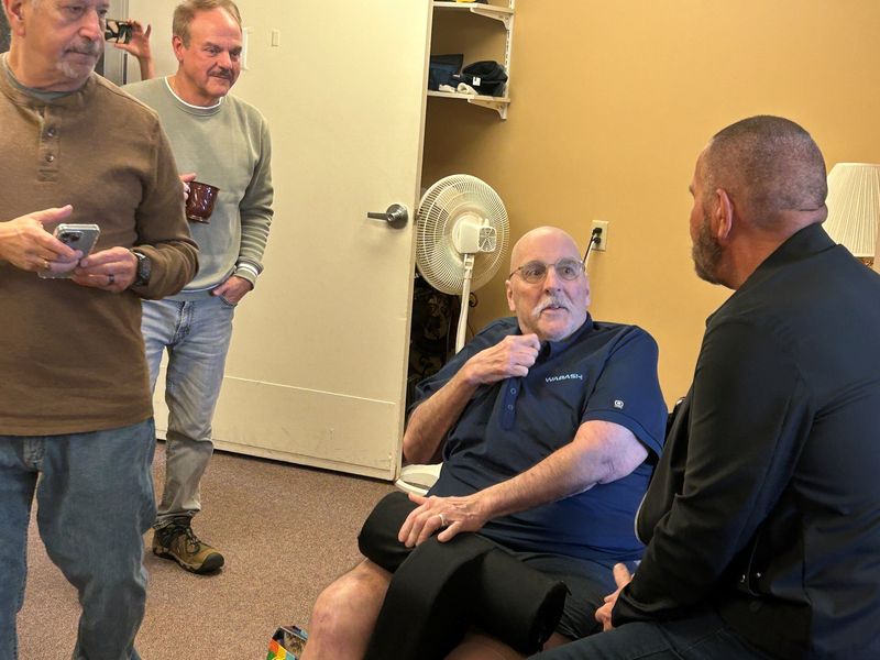 Dave Thompson, seated, chats with friends Sunday, Nov. 23, 2025, who included childhood buddies, fraternity brothers and friends and neighbors from Lafayette. They came from all over the state to celebrate Thompson's 66th birthday in a surprise party.