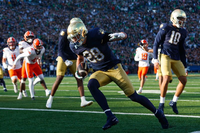 Notre Dame safety Luke Talich (28) returns a blocked punt for a touchdown in the first half of a NCAA football game against Syracuse at Notre Dame Stadium on Saturday, Nov. 22, 2025, in South Bend.
