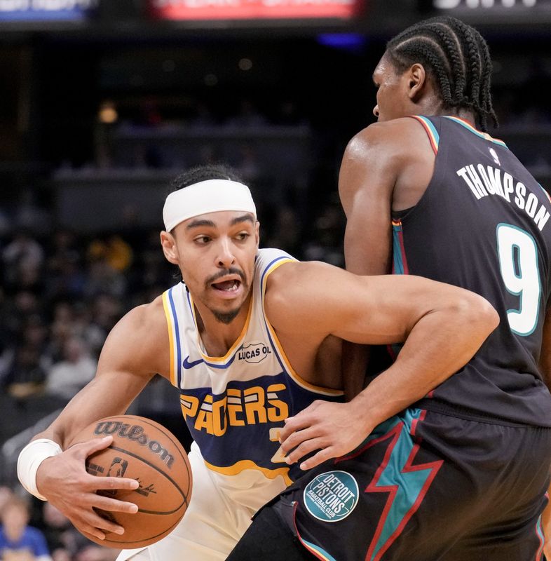 Indiana Pacers guard Andrew Nembhard (2) gets past Detroit Pistons guard Ausar Thompson (9) during a game Monday, Nov. 24, 2025, at Gainbridge Fieldhouse in Indianapolis. The Pistons defeated the Pacers 122-117.