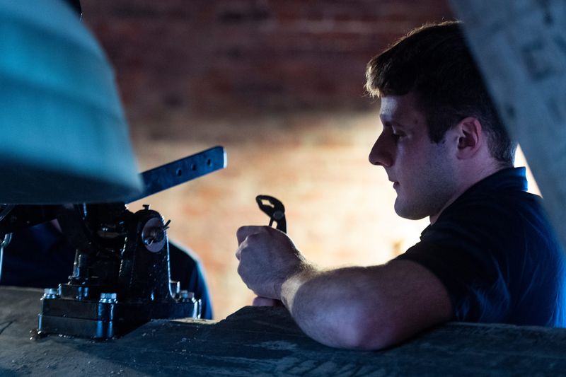 University of Southern Indiana student with the Center for Applied Research Mason Eickhoff installs the new drop hammer on the bell of the Old Courthouse after the original 134-year-old hammer broke in May in Evansville, Ind., Tuesday, Nov. 25, 2025.