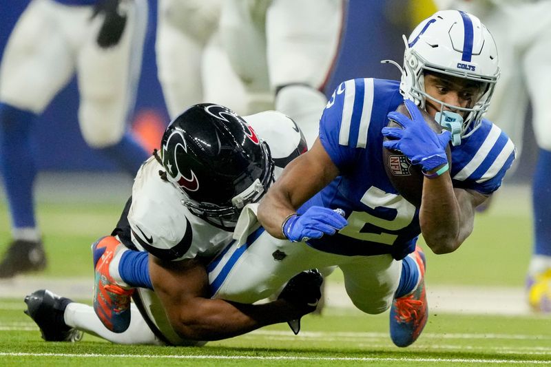 Indianapolis Colts wide receiver Josh Downs (2) is brought down by Houston Texans cornerback Myles Bryant (25) on Sunday, Nov. 30, 2025, during a game at Lucas Oil Stadium in Indianapolis.