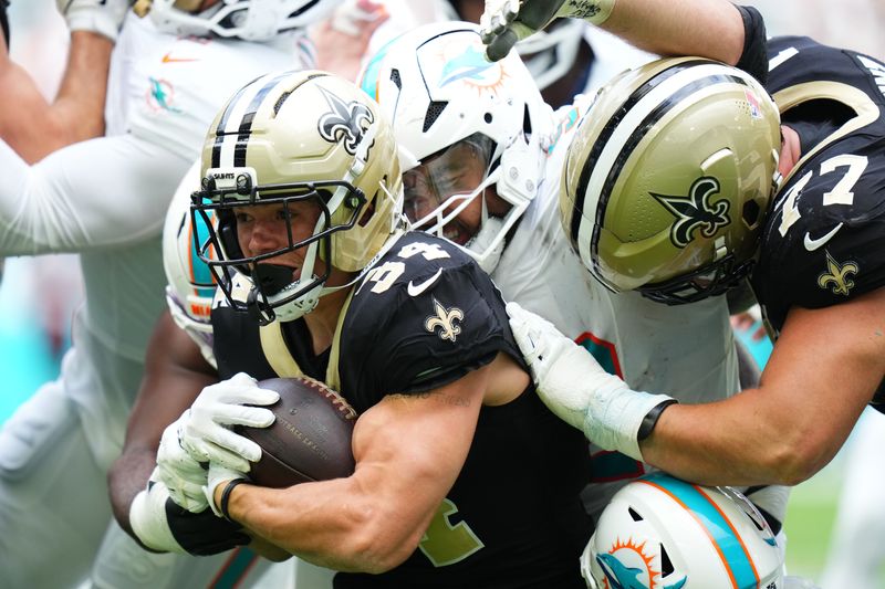 New Orleans Saints running back Evan Hull carries the ball against the Miami Dolphins.