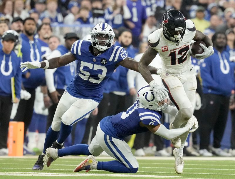 Indianapolis Colts safety Camryn Bynum (0) brings down Houston Texans wide receiver Nico Collins (12) on Sunday, Nov. 30, 2025, during a game at Lucas Oil Stadium in Indianapolis.