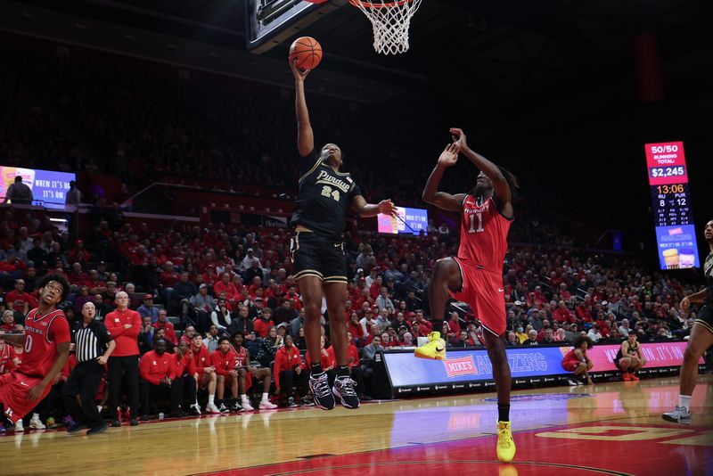 Dec 2, 2025; Piscataway, New Jersey, USA; Purdue Boilermakers guard Gicarri Harris (24) drives to the basket as Rutgers Scarlet Knights forward Christopher Nwuli (11) defends during the first half at Jersey Mike's Arena. Mandatory Credit: Vincent Carchietta-Imagn Images