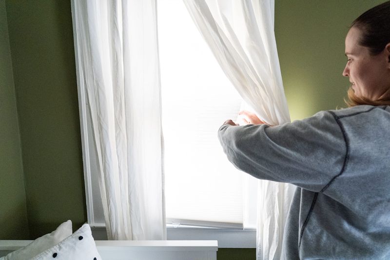 Lindsay Trameri shows a winterized window Thursday, Dec. 4, 2025, inside her Indianapolis area home. Aside from putting film on widows, Trameri and her partner added attic insulation to reduce energy usage fees.