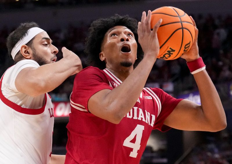 Louisville Cardinals center Aly Khalifa (15) defends Indiana Hoosiers forward Sam Alexis (4) as he shoots during a game Saturday, Dec. 6, 2025, at Gainbridge Fieldhouse in Indianapolis. Louisville defeated Indiana 87-78.