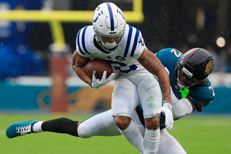 Indianapolis Colts wide receiver Josh Downs (2) is tackled by Jacksonville Jaguars cornerback Jarrian Jones (22) during the second quarter of an NFL football game at EverBank Stadium, Sunday, Dec. 7, 2025, in Jacksonville, Fla. The Jaguars defeated the Colts 36-19.