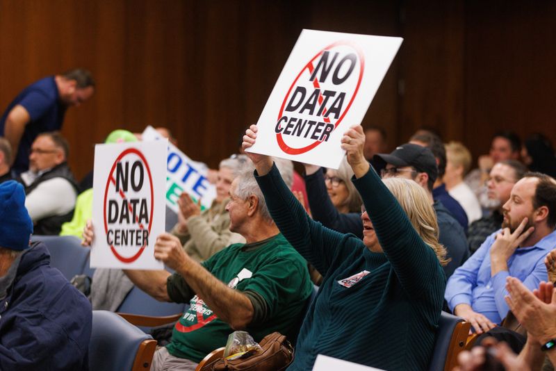 Interested residents cheer after St. Jospeh County Council members voted to reject a proposal rezoning farmland between South Bend and New Carlisle that would have been used for a data center on Wednesday, Dec. 10, 2025.