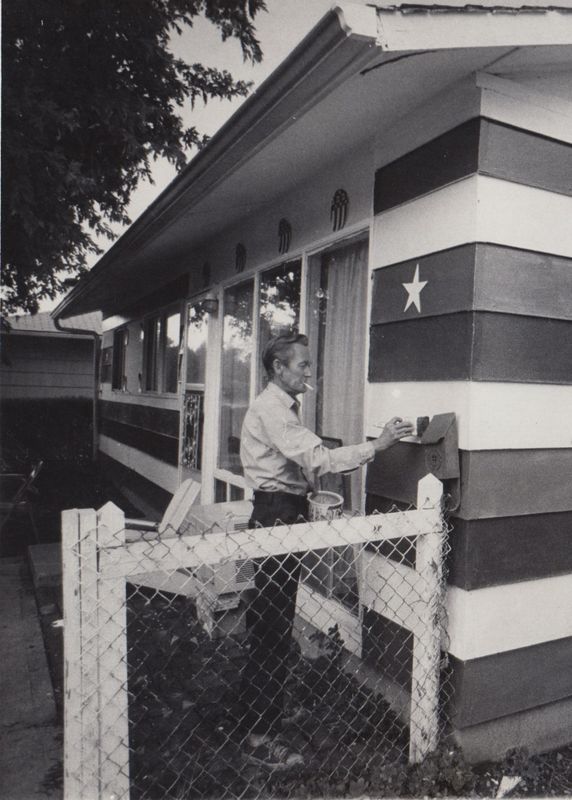 George L. Off puts the finishing touches of red, white and blue paint on his house at 4408 Bertrand Road in honor the Bicentennial.
