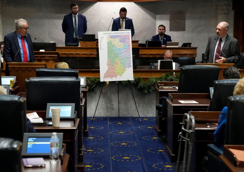 Indiana state Sen. Mike Gaskill, R-Pendleton, (left) discusses with state Sen. Greg Walker, R-Columbus, as the Senate gathers during mid-cycle session to vote on redistricting Thursday, Dec. 11, 2025, in the Senate Chambers of the Indiana Statehouse in Indianapolis.