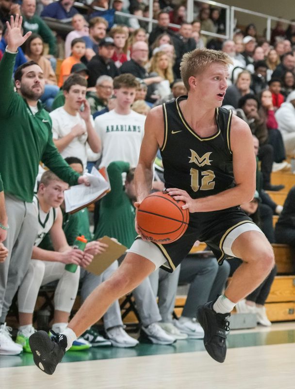 Mt. Vernon Luke Ertel (12) jumps back Friday, Dec. 12, 2025, during a game between Pendleton Heights and Mt. Vernon at Pendleton Heights High School in Pendleton.