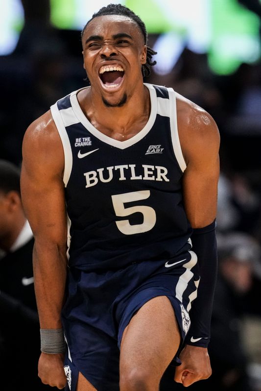Butler Bulldogs forward Michael Ajayi (5) celebrates Saturday, Dec. 13, 2025, after winning a game between the Butler Bulldogs and the Providence Friars at Hinkle Fieldhouse in Indianapolis. The Butler Bulldogs defeated the Providence Friars in double overtime, 113-110.