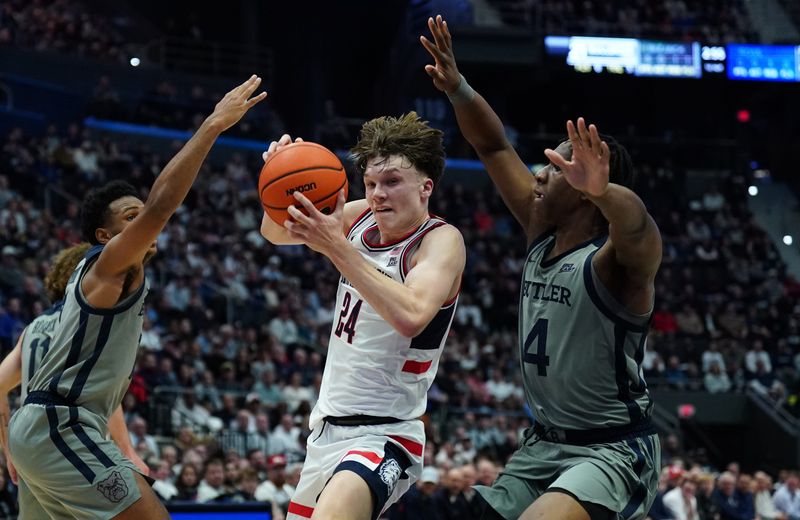 Dec 16, 2025; Storrs, Connecticut, USA; UConn Huskies guard Braylon Mullins (24) drives the ball against Butler Bulldogs forward Efeosa Oliogu-Elabor (4) in the first half at Harry A. Gampel Pavilion. Mandatory Credit: David Butler II-Imagn Images