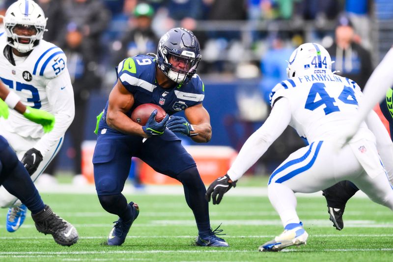 Dec 14, 2025; Seattle, Washington, USA; Seattle Seahawks running back Kenneth Walker III (9) rushes against the Indianapolis Colts during the third quarter at Lumen Field. Mandatory Credit: Steven Bisig-Imagn Images