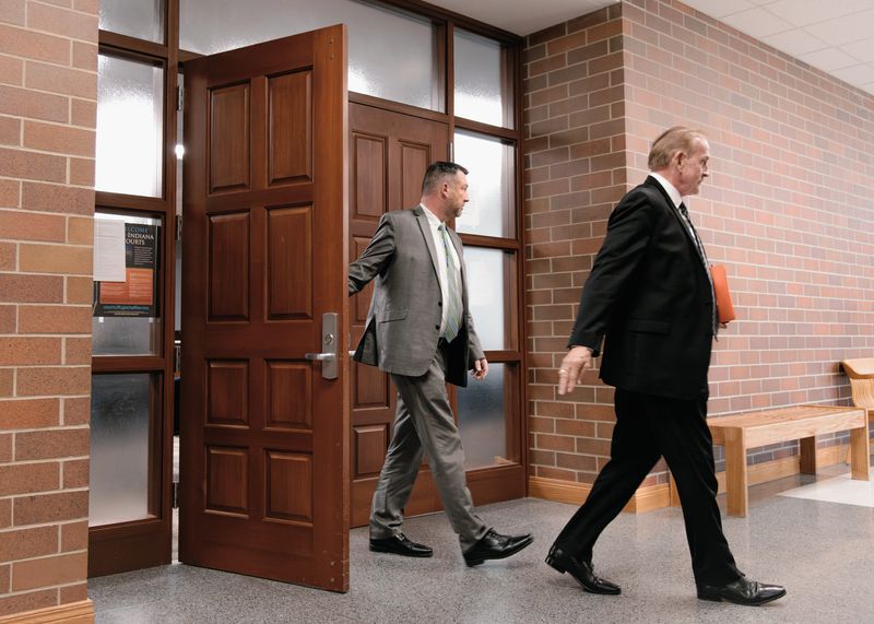 Former Vanderburgh County Commission President Ben Shoulders (left) exits Warrick County Superior Court in Boonville, Indiana, on Friday, Dec. 19, 2025, alongside his attorney, Scott Danks.
